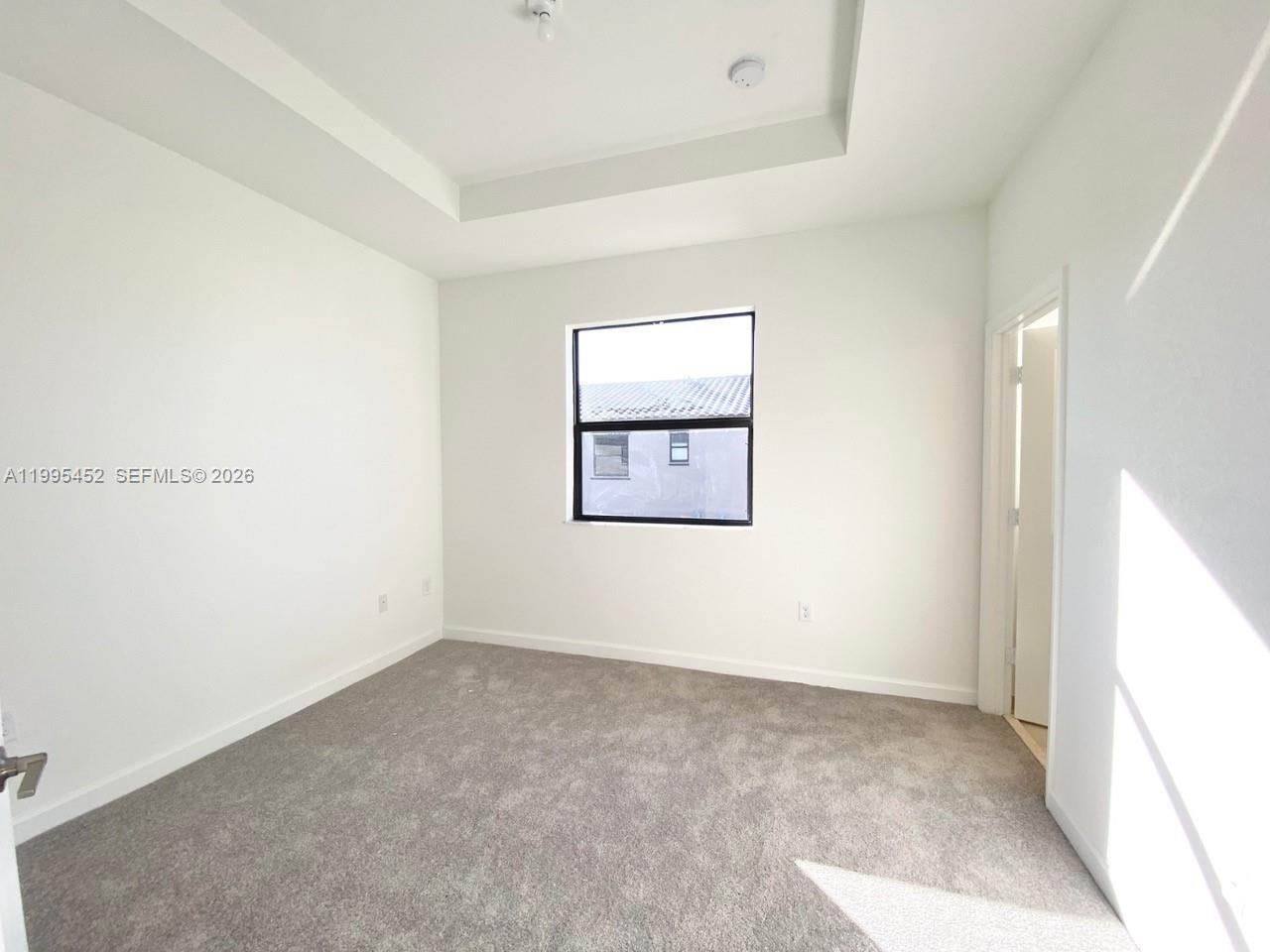 24920 Southwest 112th Court Homestead, FL 33032 - Photo 15 of 48 an empty room with a window