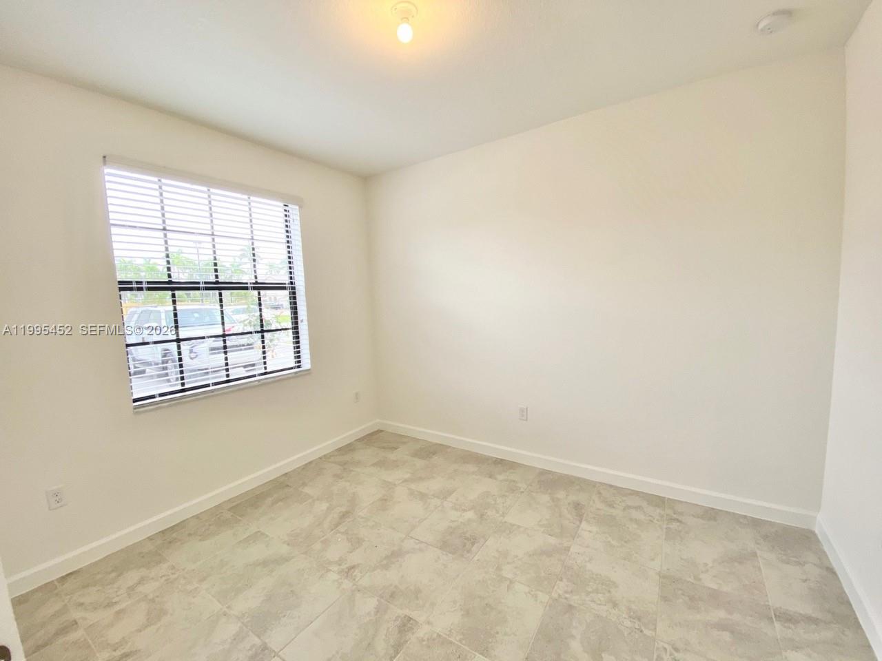 24920 Southwest 112th Court Homestead, FL 33032 - Photo 22 of 48 an empty room with a window