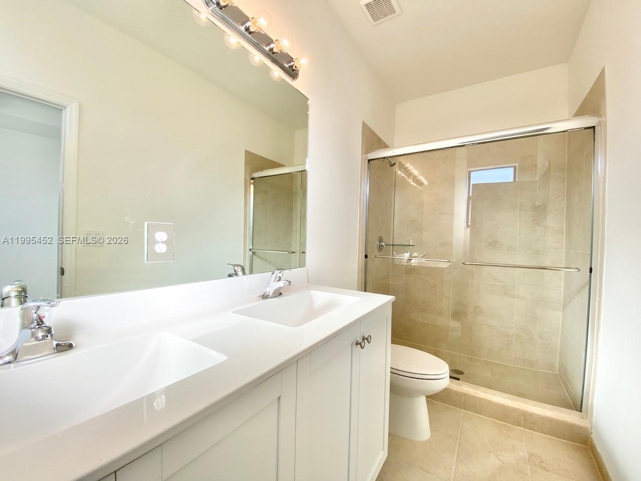 24920 Southwest 112th Court Homestead, FL 33032 - Photo 23 of 48 a bathroom with a sink a toilet and shower