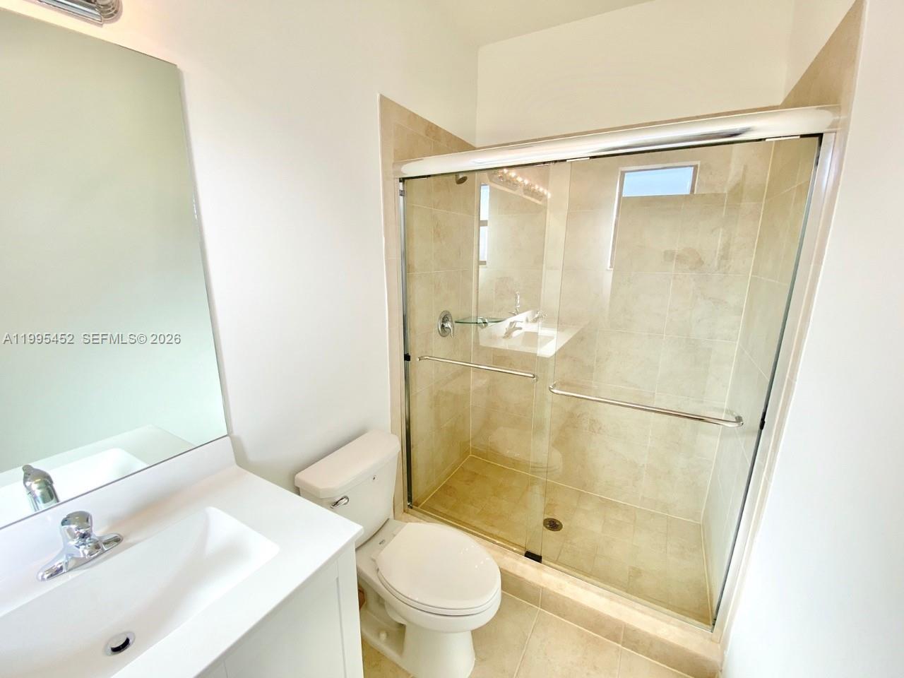 24920 Southwest 112th Court Homestead, FL 33032 - Photo 24 of 48 a bathroom with a shower and a toilet sink