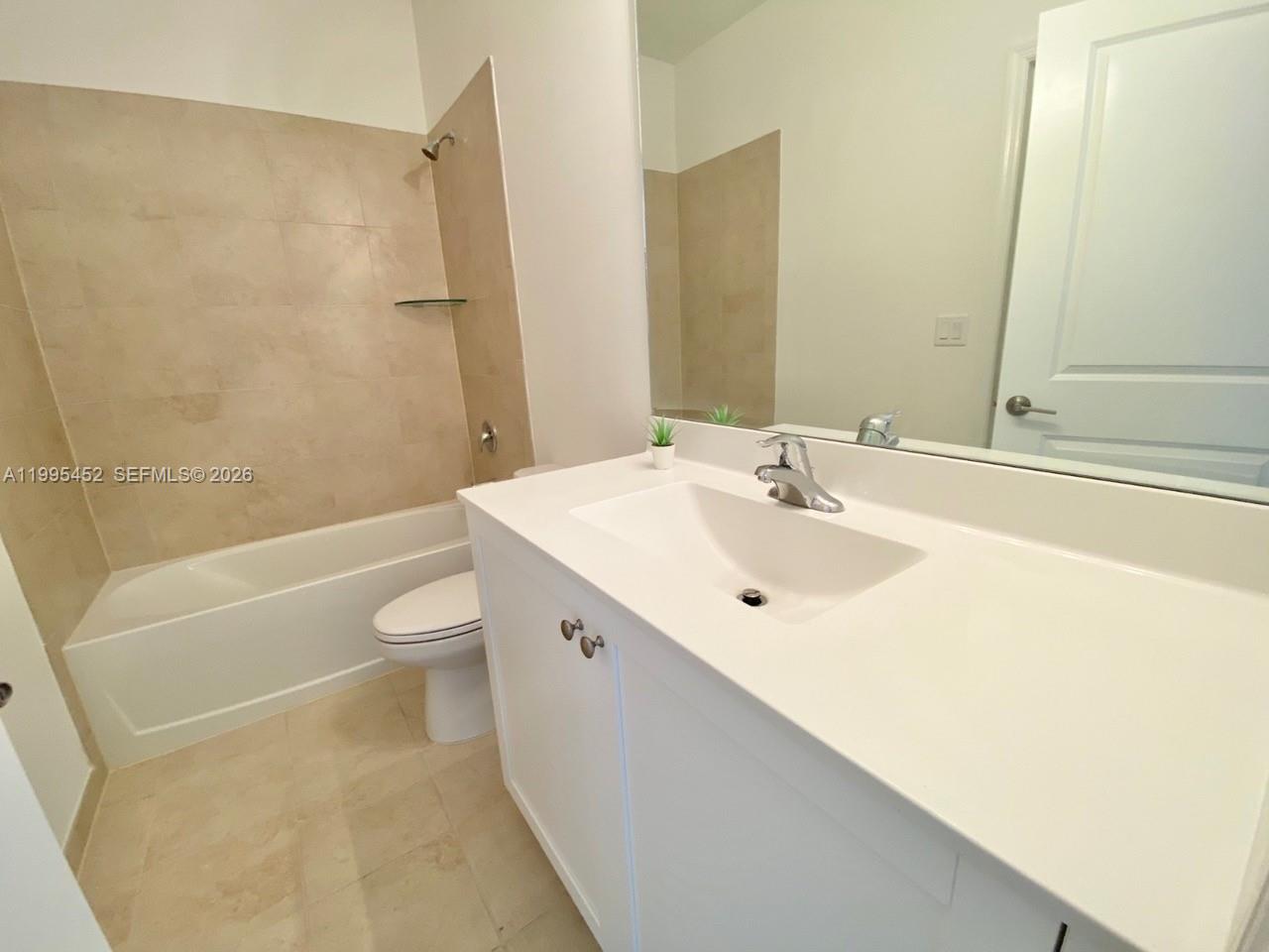 24920 Southwest 112th Court Homestead, FL 33032 - Photo 27 of 48 a bathroom with a sink a toilet and a bathtub