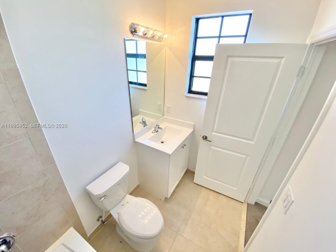 24920 Southwest 112th Court Homestead, FL 33032 - Photo 28 of 48 a white toilet sitting next to a small sink