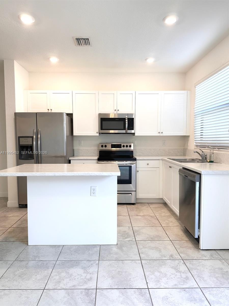 24920 Southwest 112th Court Homestead, FL 33032 - Photo 3 of 48 a kitchen with a cabinets and appliances
