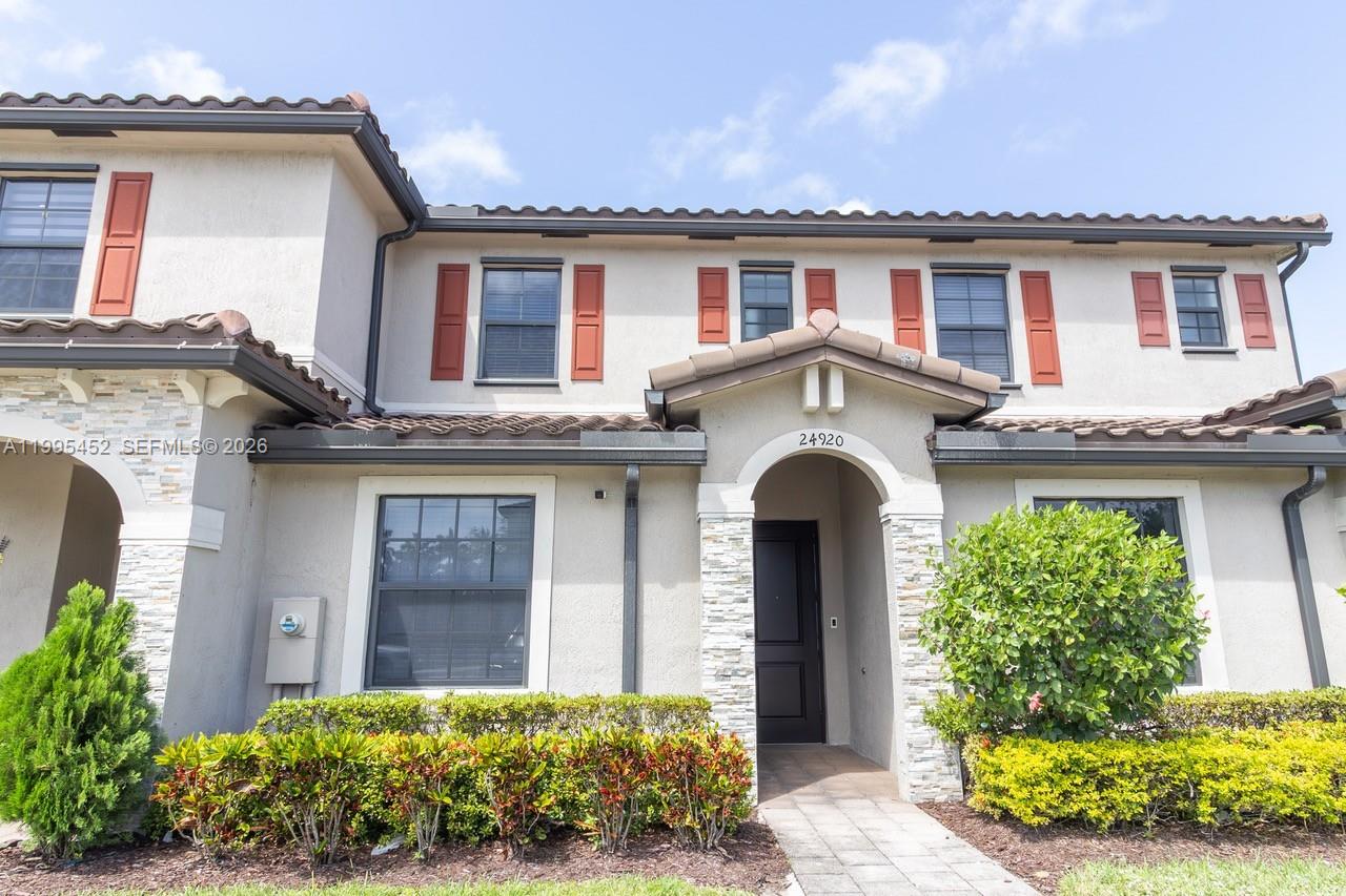 24920 Southwest 112th Court Homestead, FL 33032 - Photo 33 of 48 front view of a house with a garden
