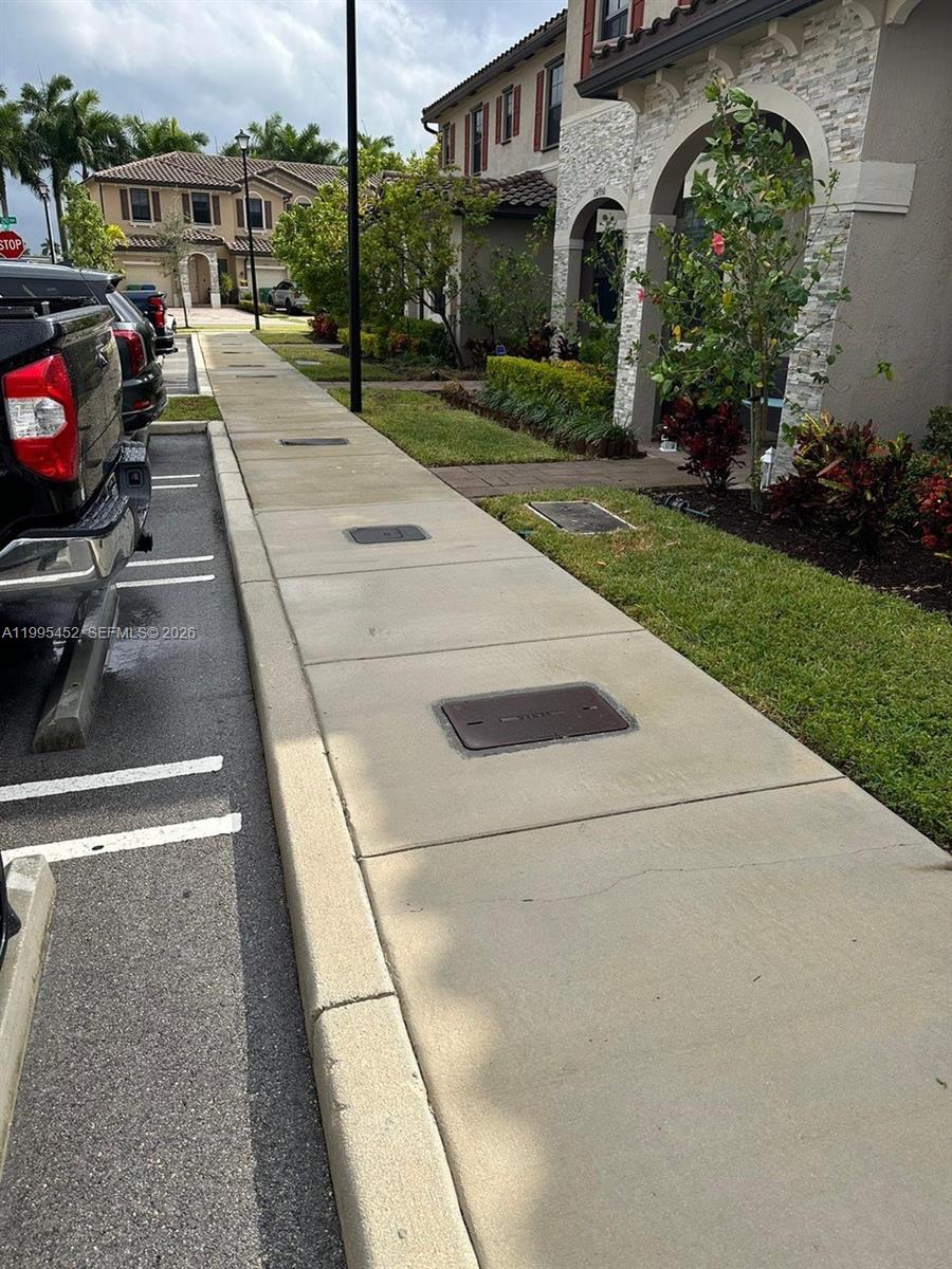 24920 Southwest 112th Court Homestead, FL 33032 - Photo 37 of 48 a view of a street with a cars park side of road