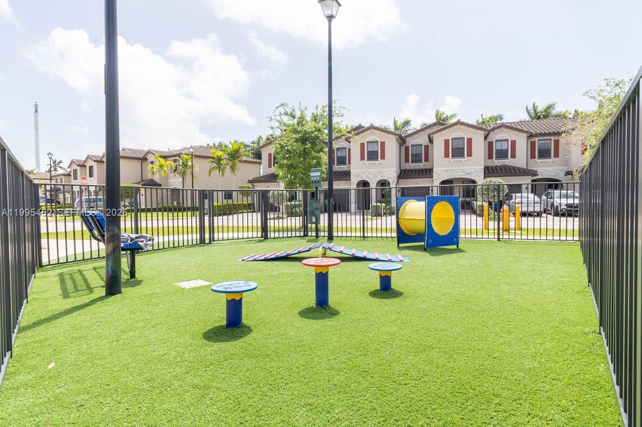 24920 Southwest 112th Court Homestead, FL 33032 - Photo 48 of 48 a view of a park with swings on the roof deck