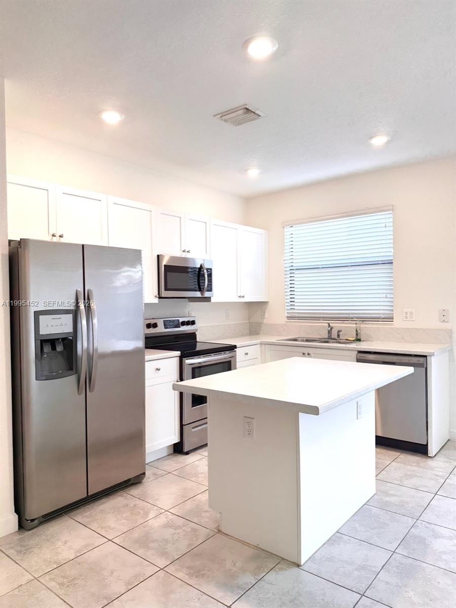 24920 Southwest 112th Court Homestead, FL 33032 - Photo 5 of 48 a kitchen with a sink stove and refrigerator