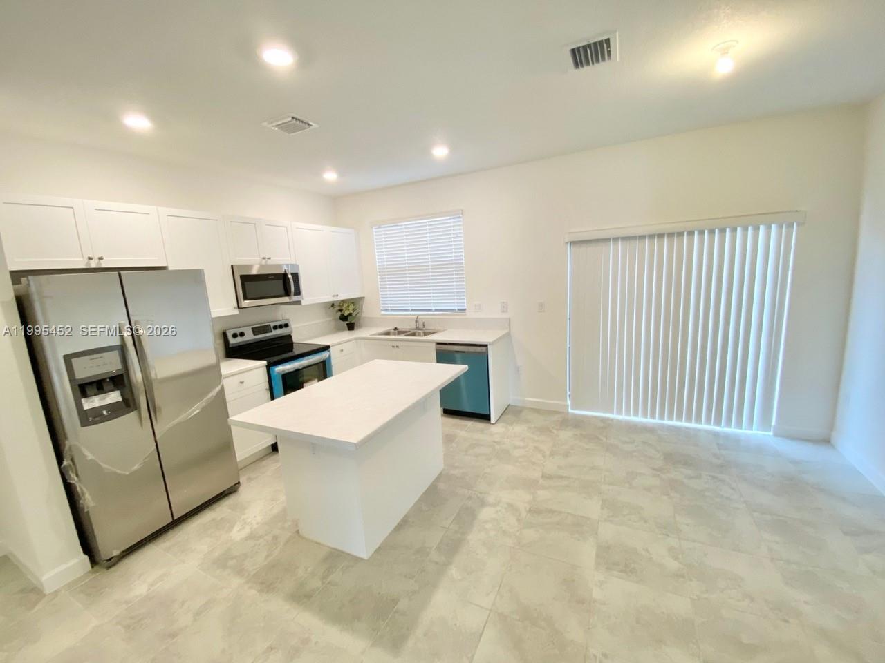 24920 Southwest 112th Court Homestead, FL 33032 - Photo 6 of 48 a view of kitchen with stainless steel appliances refrigerator stove microwave and sink