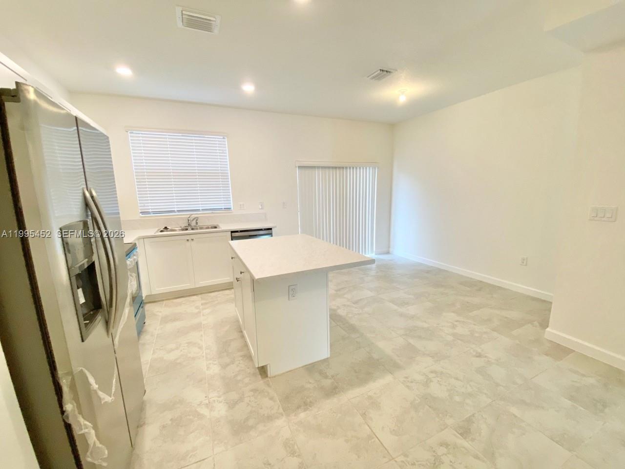24920 Southwest 112th Court Homestead, FL 33032 - Photo 7 of 48 a view of a kitchen with stainless steel appliances a refrigerator and a sink