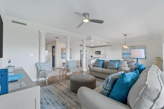 a living room with furniture and a chandelier
