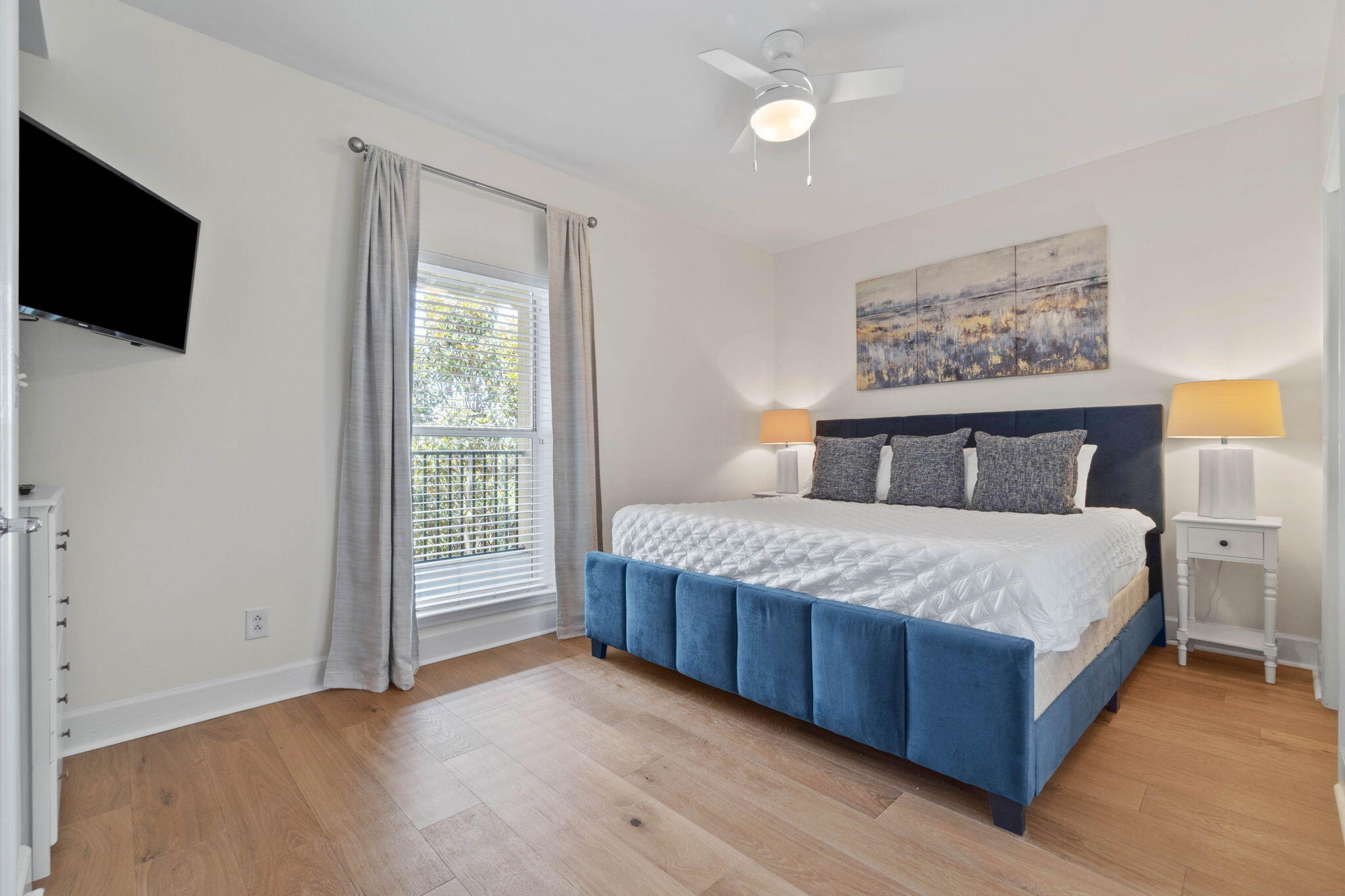 1732 West County Highway 30A, Unit 402 Santa Rosa Beach, FL 32459 - Photo 23 of 32 a bedroom with a large bed and a flat tv screen on dresser
