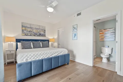 a bedroom with a large bed and a chandelier