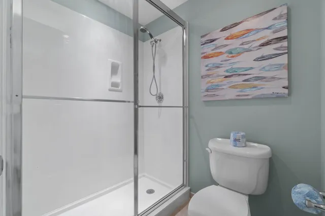 a bathroom with a toilet and a shower