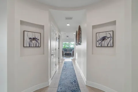 a view of a hallway with wooden floor and a painting