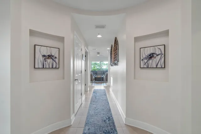 a view of a hallway with wooden floor and a painting
