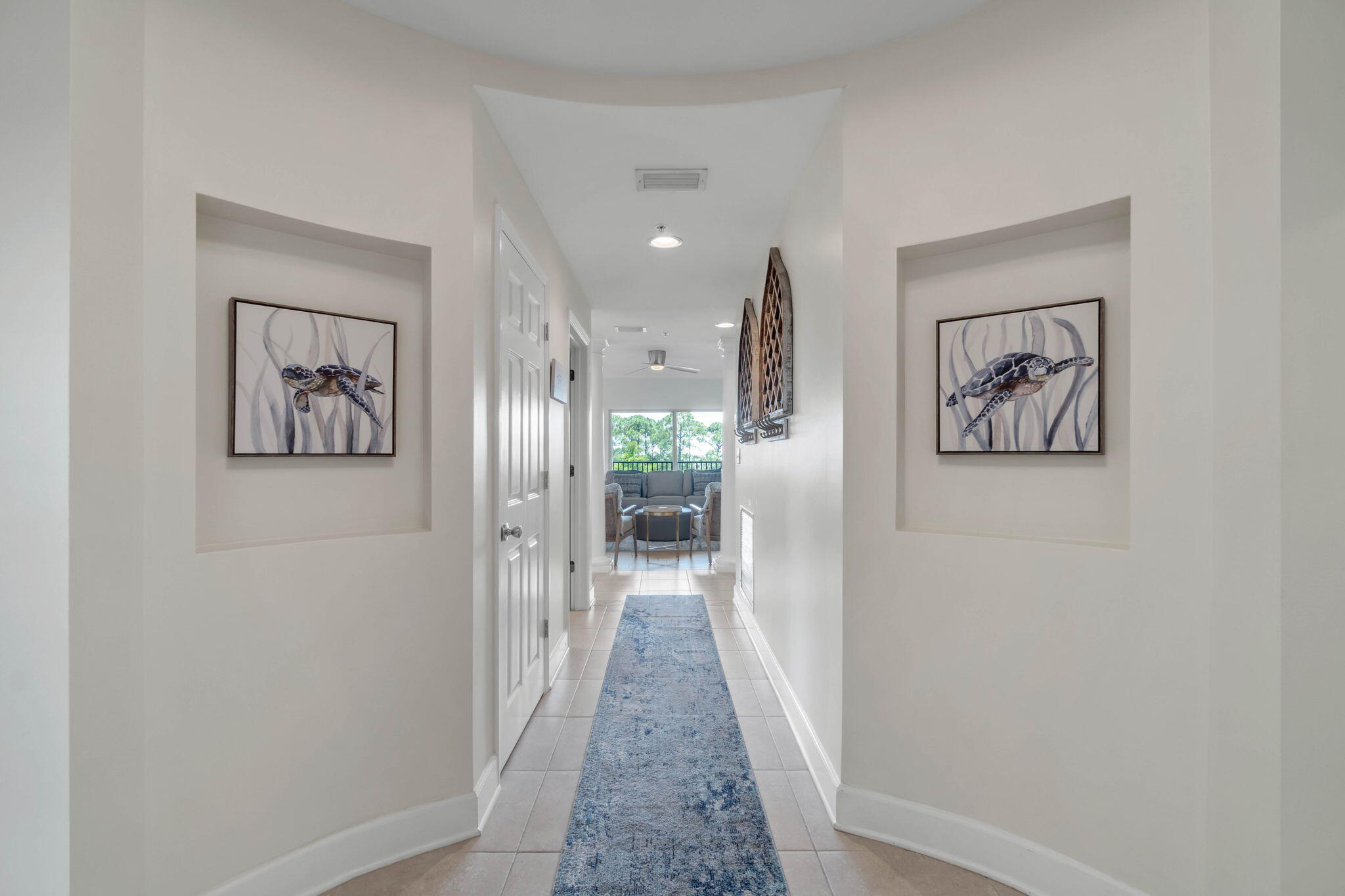 1732 West County Highway 30A, Unit 402 Santa Rosa Beach, FL 32459 - Photo 10 of 32 a view of a hallway with wooden floor and a painting