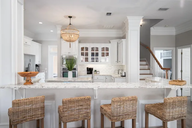 a kitchen with stainless steel appliances granite countertop a sink and a refrigerator