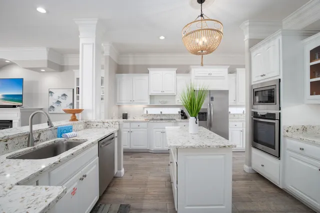 a kitchen with white cabinets and stainless steel appliances