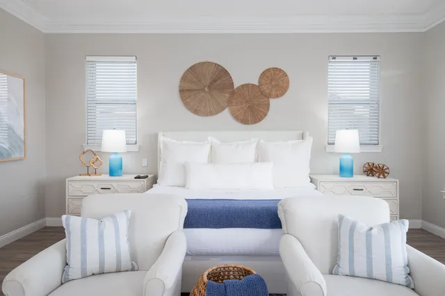 a living room with furniture and a large window with wooden floor