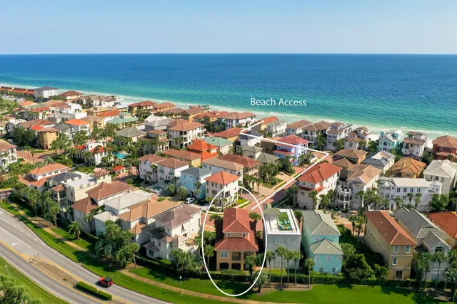 an aerial view of residential houses with outdoor space and river