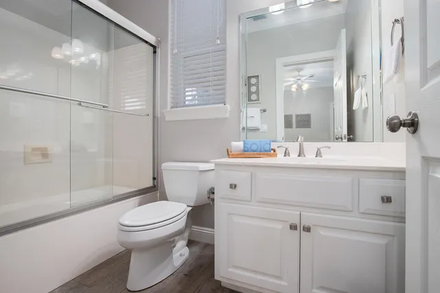 a bedroom with a bed a table and a potted plant