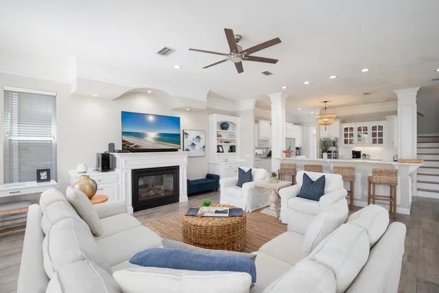 a living room with furniture a fireplace and a flat screen tv