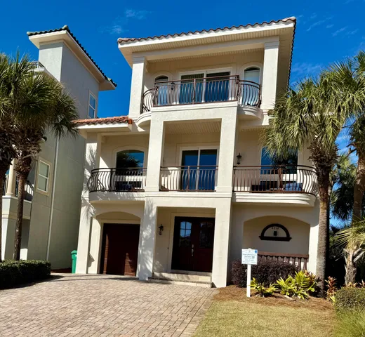 an aerial view of residential houses with outdoor space and lake view