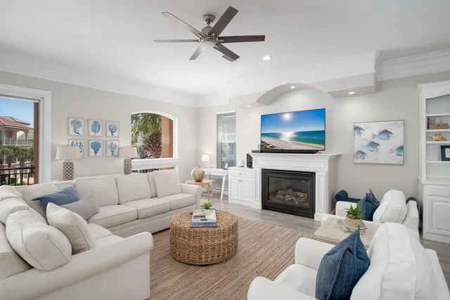 a living room with furniture a fireplace and a flat screen tv