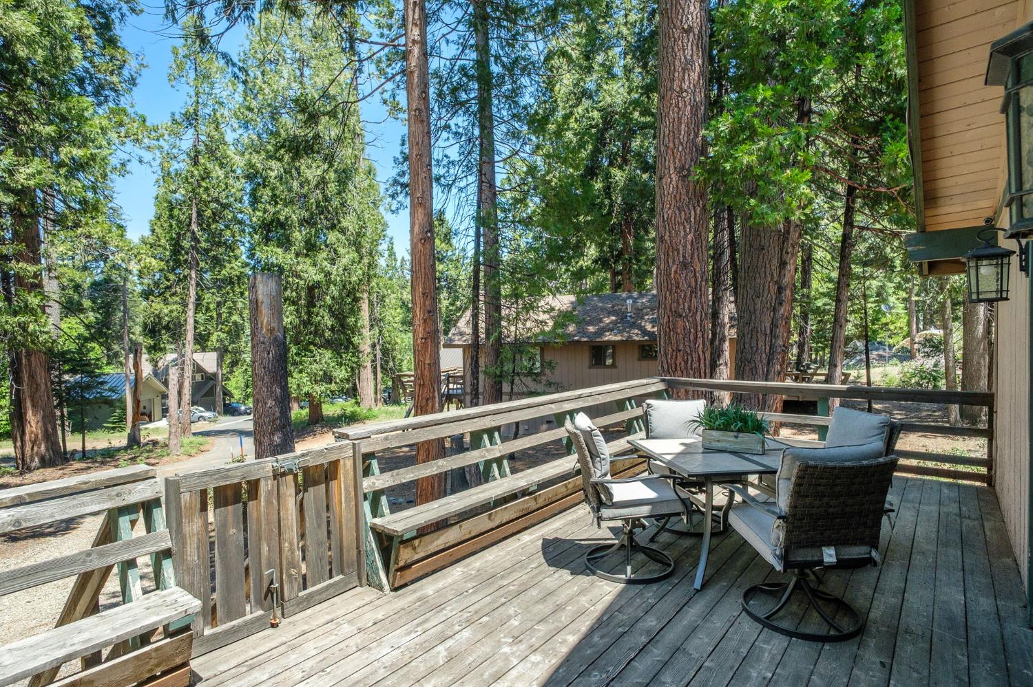 42488 Rock Ledge Road Shaver Lake, CA 93664 - Photo 7 of 26 a view of balcony with chairs and wooden fence