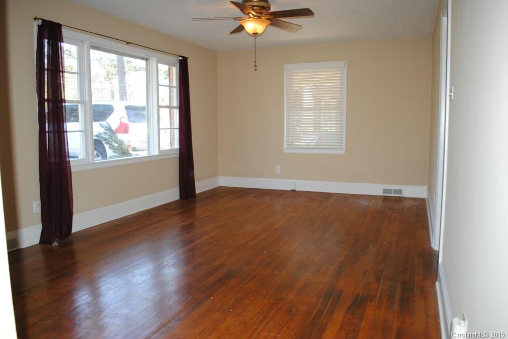 2057 Eaton Road Charlotte, NC 28205 - Photo 2 of 13 a view of an empty room with wooden floor and a window