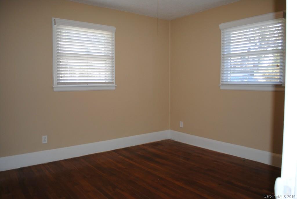 2057 Eaton Road Charlotte, NC 28205 - Photo 11 of 13 a view of an empty room with wooden floor and a window