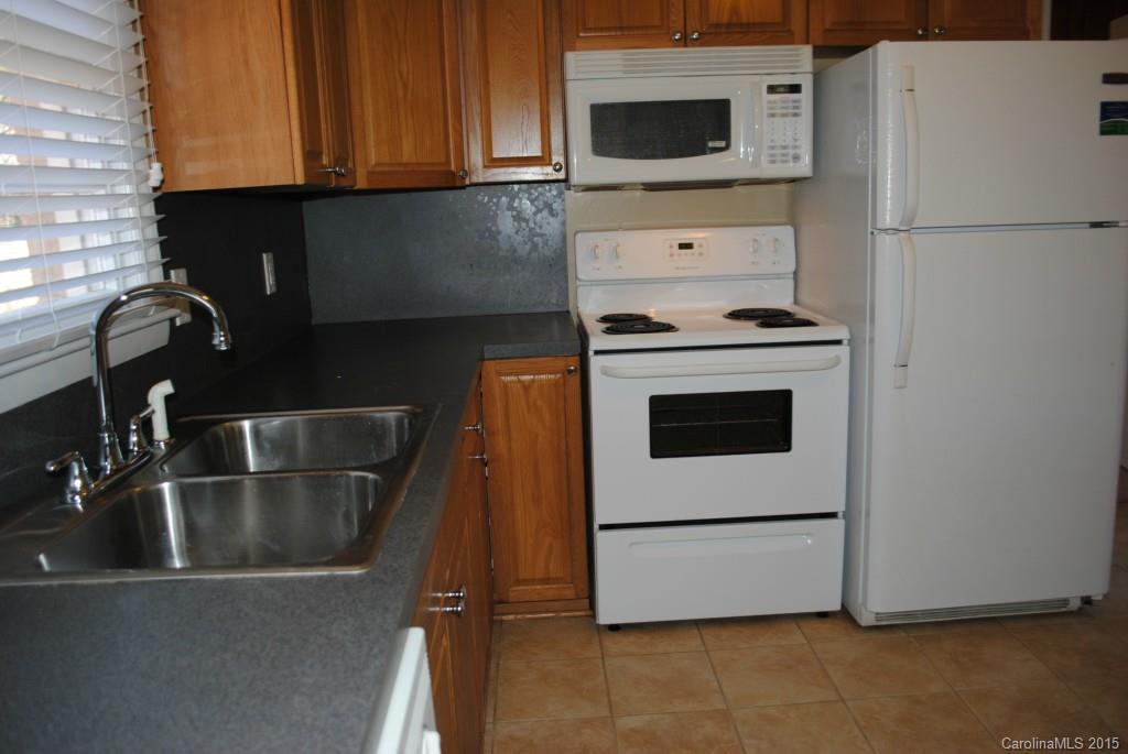 2057 Eaton Road Charlotte, NC 28205 - Photo 3 of 13 a kitchen with a white stove top oven and sink