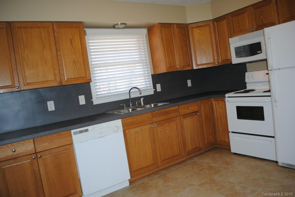 2057 Eaton Road Charlotte, NC 28205 - Photo 4 of 13 a kitchen with granite countertop cabinets stainless steel appliances and sink
