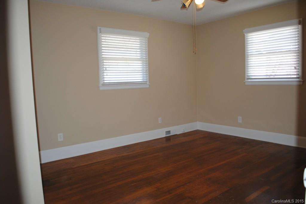 2057 Eaton Road Charlotte, NC 28205 - Photo 6 of 13 an empty room with wooden floor and windows