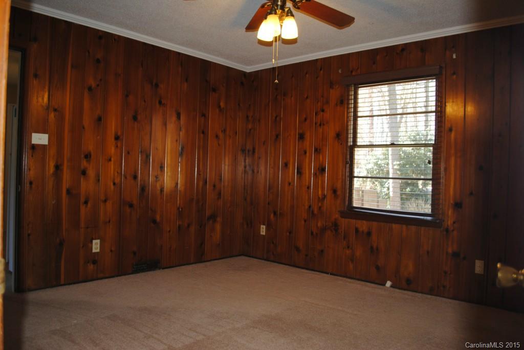 2057 Eaton Road Charlotte, NC 28205 - Photo 7 of 13 an empty room with a window and a chandelier fan
