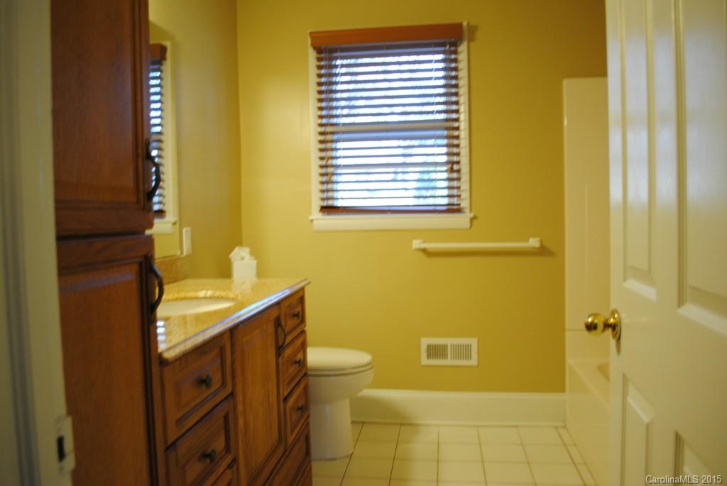2057 Eaton Road Charlotte, NC 28205 - Photo 8 of 13 a bathroom with a granite countertop sink and a toilet