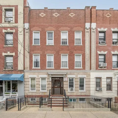 a front view of a brick building with many windows