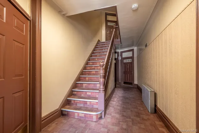 a utility room with multiple dryer and washer