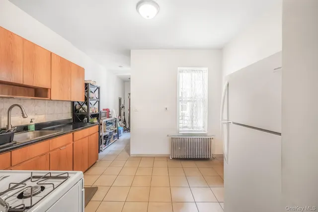 a kitchen with stainless steel appliances granite countertop a refrigerator sink and cabinets