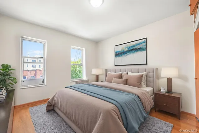a bedroom with bed and a potted plant