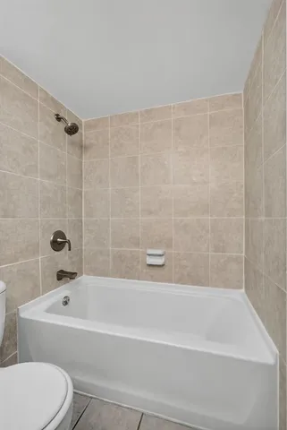 a bathroom with a bathtub and a toilet