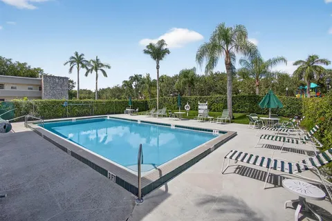 a view of a swimming pool with a patio and a garden