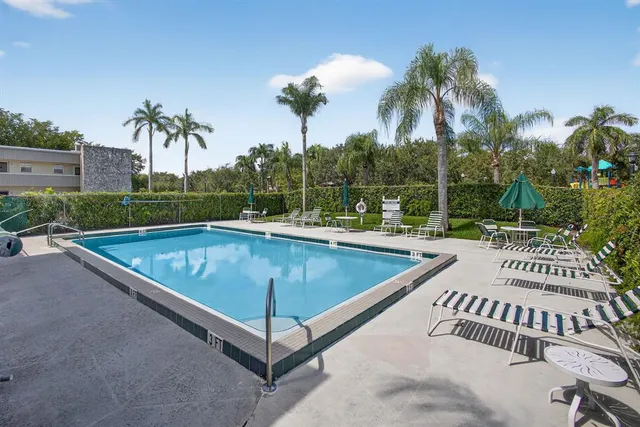 a view of a swimming pool with a patio and a garden