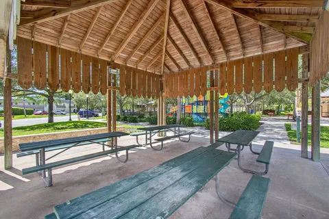 a building outdoor space with patio furniture and garden