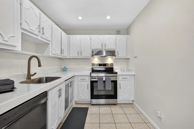 a kitchen with a sink cabinets and appliances