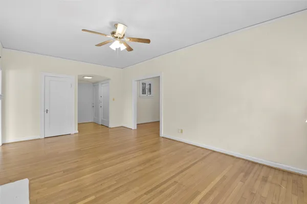 a view of an empty room with wooden floor