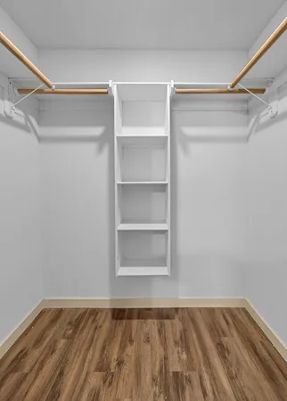 a view of walk in closet with empty racks
