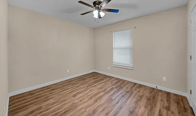 wooden floor in an empty room with a window