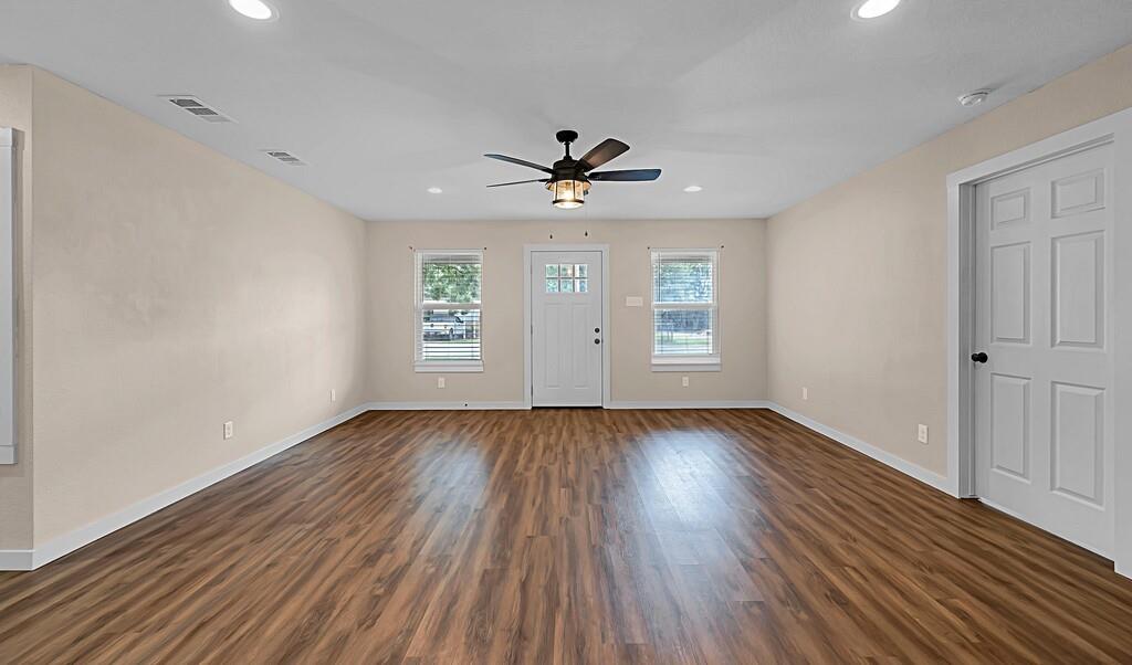 210 North Harrison Street McGregor, TX 76657 - Photo 5 of 25 an empty room with wooden floor and windows
