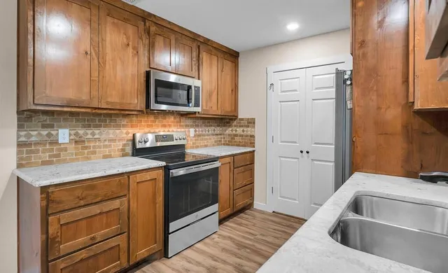 a kitchen with a sink stove and microwave